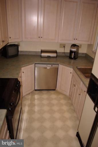 3503 Russell Road Alexandria, VA 22305 - Photo 3 of 16 a view of kitchen with stainless steel appliances granite countertop a stove a sink and a microwave