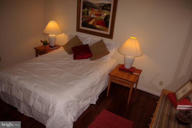 3503 Russell Road Alexandria, VA 22305 - Photo 8 of 16 a bed room with a bed and a lamp