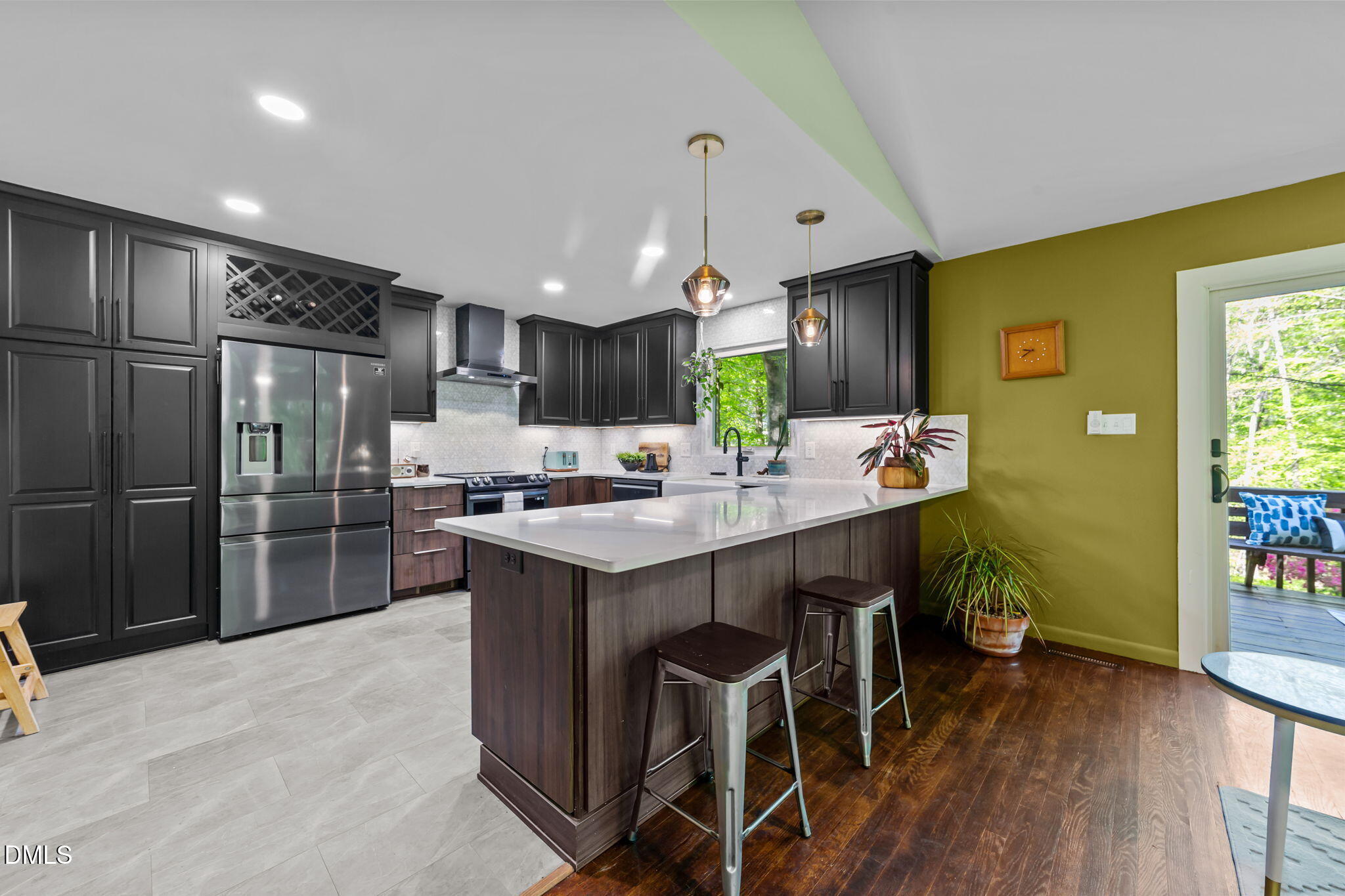 105 Barcliff Terrace Cary, NC 27518 - Photo 5 of 47 a kitchen with kitchen island a stove a sink a refrigerator and a dining table with wooden floor