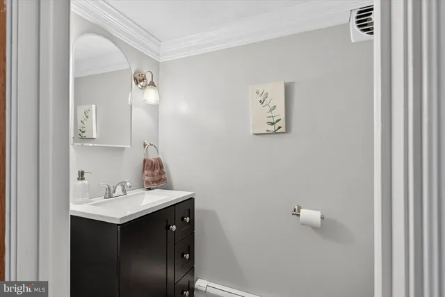 a living room with furniture and a baby crib