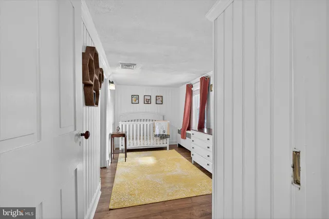 a kitchen with granite countertop a sink cabinets and wooden floor
