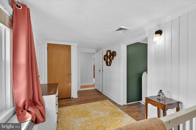 a view of a room with wooden floor and window