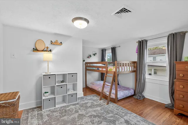 a bedroom with a bed and a desk