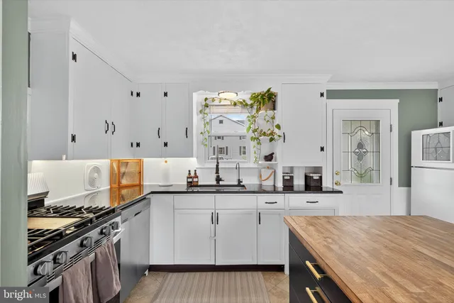 a dining room with a wooden table and chairs