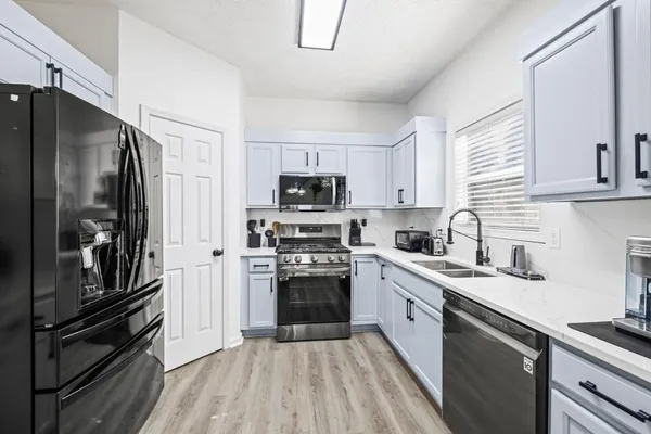 a kitchen with a sink stainless steel appliances and cabinets