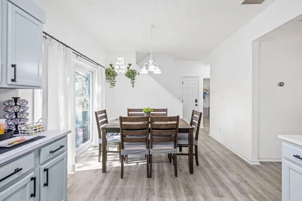 a view of a dining room with furniture and wooden floor