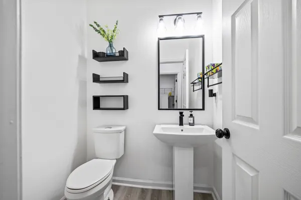 a bathroom with a toilet sink and mirror