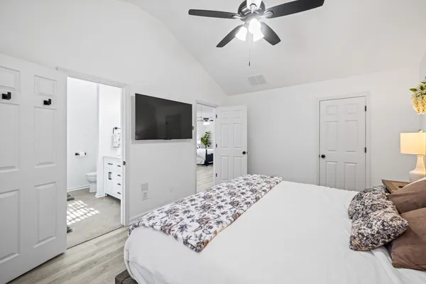 a bedroom with a bed and a flat screen tv