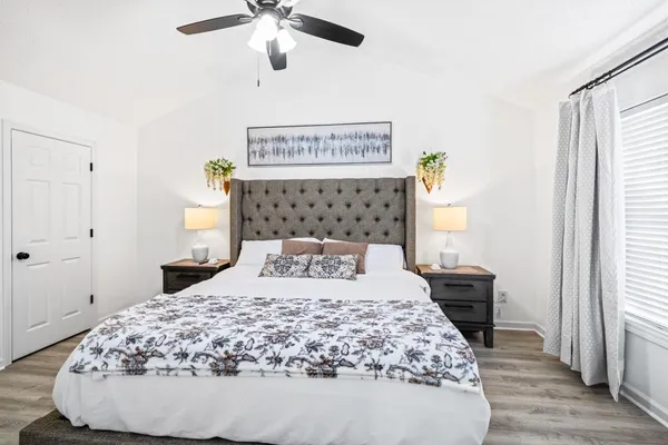 a bedroom with a bed and wooden floor