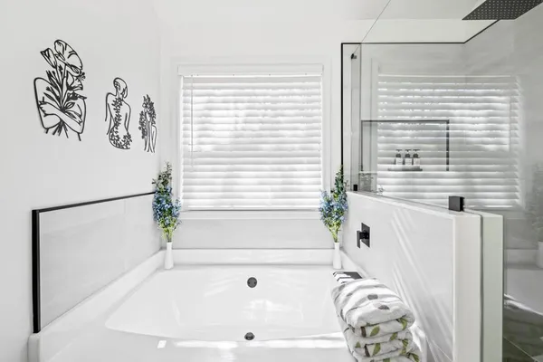 a bathroom with a bathtub and a window