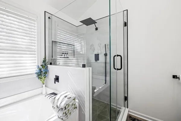 a bathroom with a bathtub and shower