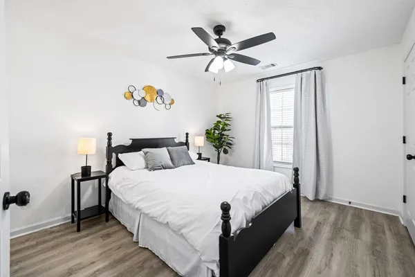 a bedroom with a bed and a window