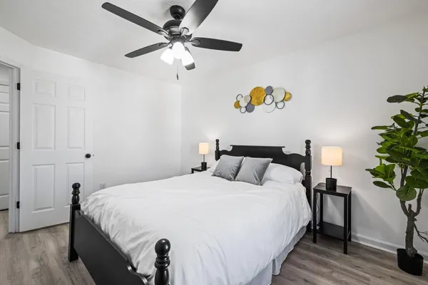 a bedroom with a bed and a chandelier