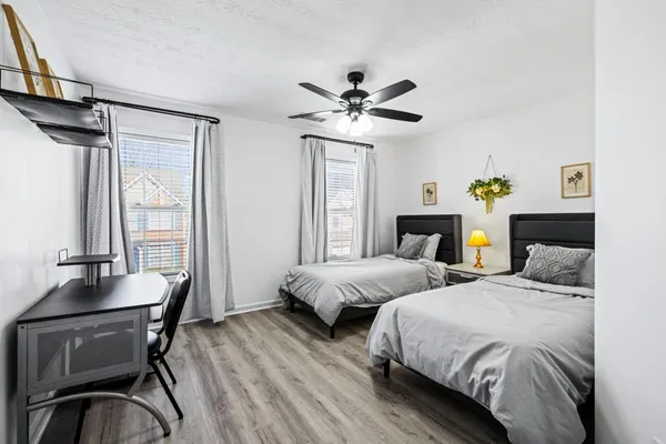 a bedroom with two beds and a window