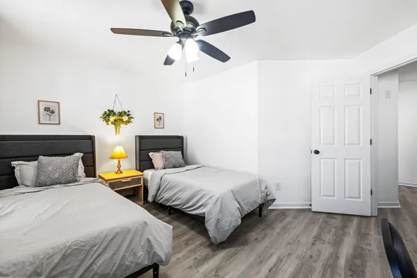 a bedroom with two beds and a chandelier