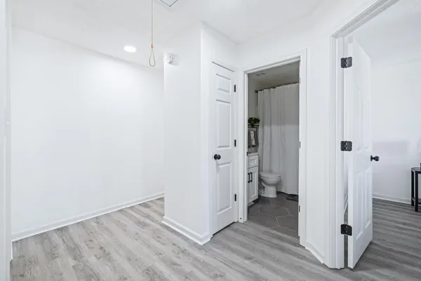 a view of a hallway with wooden floor