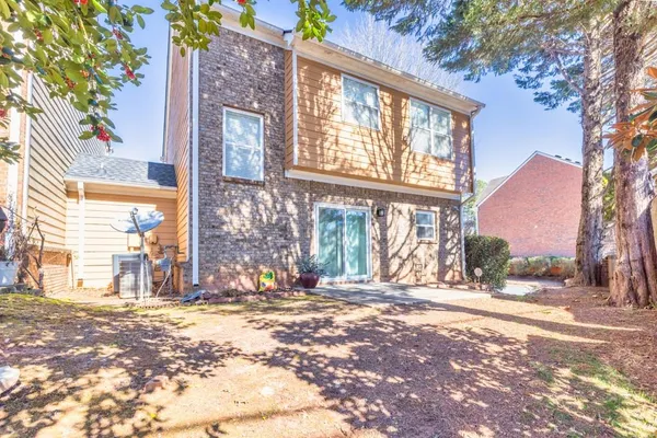 a view of a brick building next to a yard