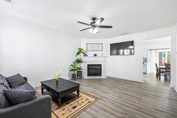 a living room with furniture a fireplace and a window