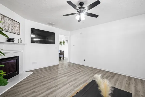 wooden floor in an empty room with a fireplace