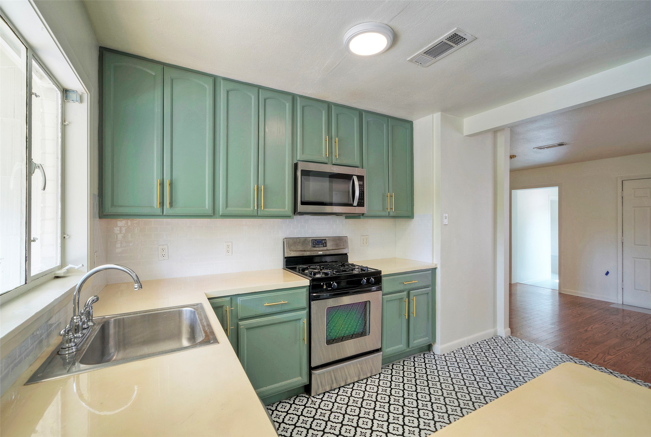 1803 Pearl Street Austin, TX 78701 - Photo 4 of 33 a kitchen with a sink and a stove top oven