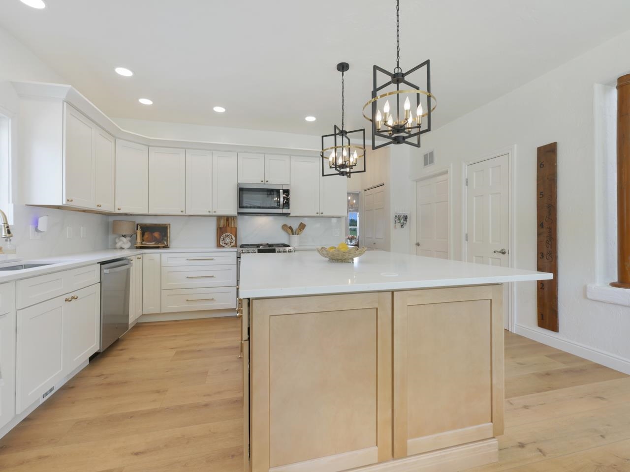 2433 H Road Grand Junction, CO 81505 - Photo 13 of 42 a kitchen with kitchen island white cabinets and stainless steel appliances