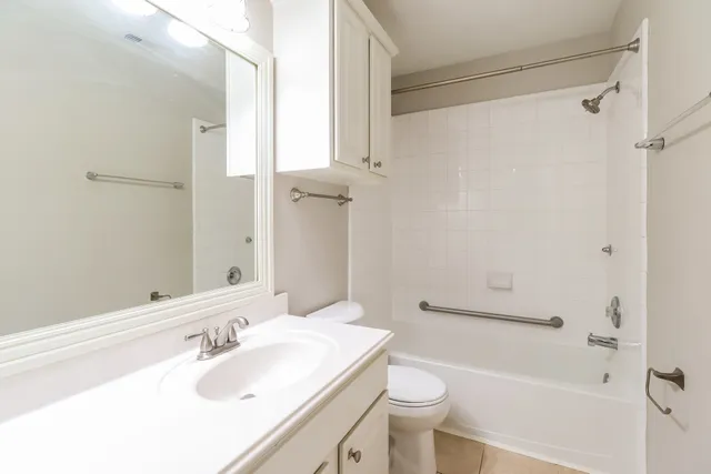 a bathroom with a sink toilet tub and shower