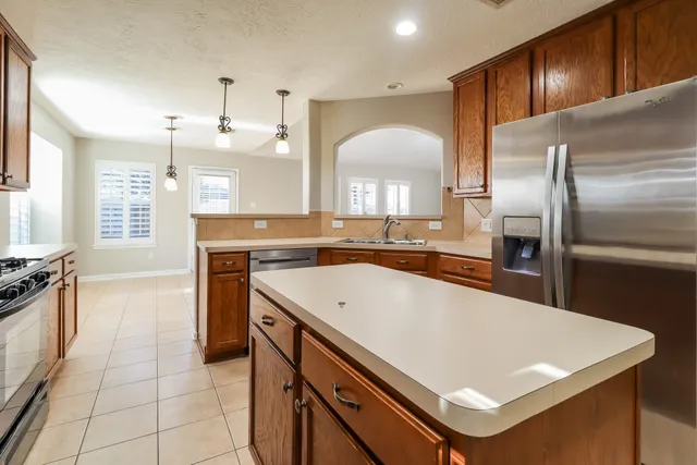 a kitchen with a stove a sink and a refrigerator