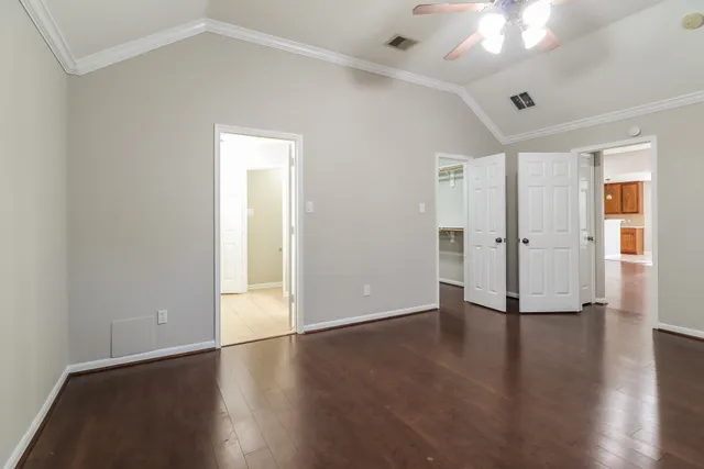 an empty room with wooden floor and a window
