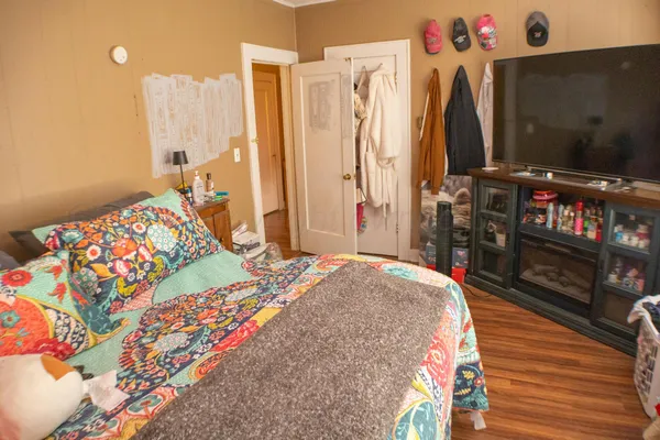 a bedroom with bed and a flat tv screen