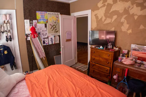 a bedroom with a bed and a flat tv screen