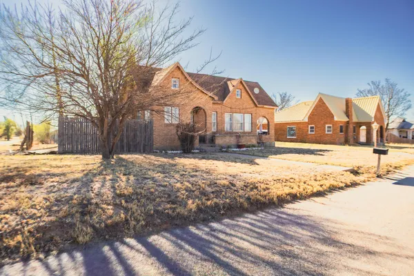 a view of large house with snow on the road