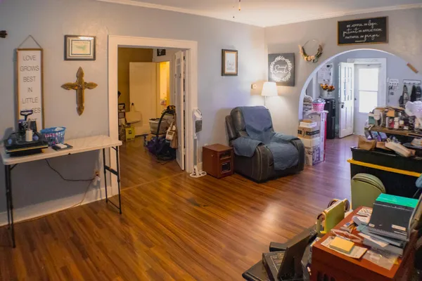a living room with furniture and a wooden floor