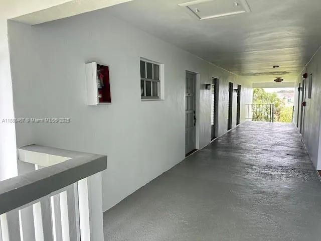 a view of a hallway with wooden floor and closet