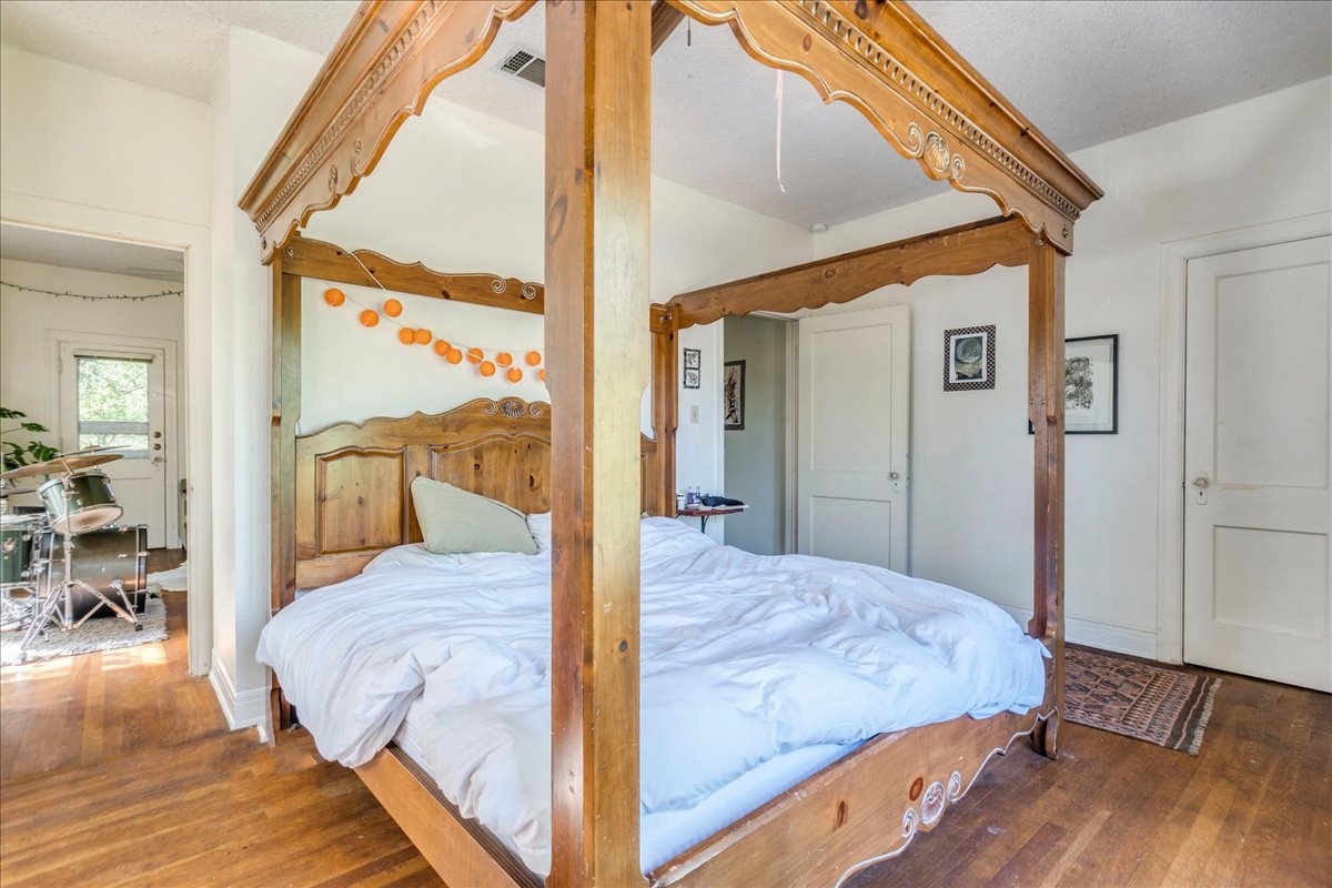 1103 West 22nd Street, Unit B Austin, TX 78705 - Photo 3 of 17 a bedroom with a large bed and a balcony view