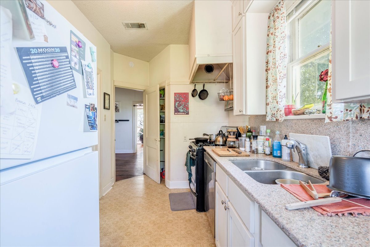 1103 West 22nd Street, Unit B Austin, TX 78705 - Photo 7 of 17 a kitchen with stainless steel appliances granite countertop a sink stove and refrigerator