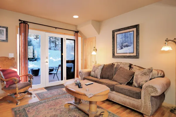 a living room with furniture and a gym