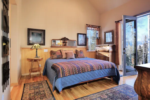 a bedroom with two bed and window