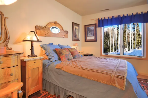 a view of wooden house with a deck