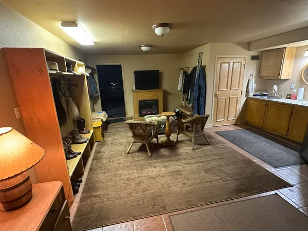 a living room with furniture and a floor to ceiling window