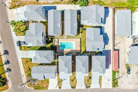 an aerial view of residential houses with outdoor space