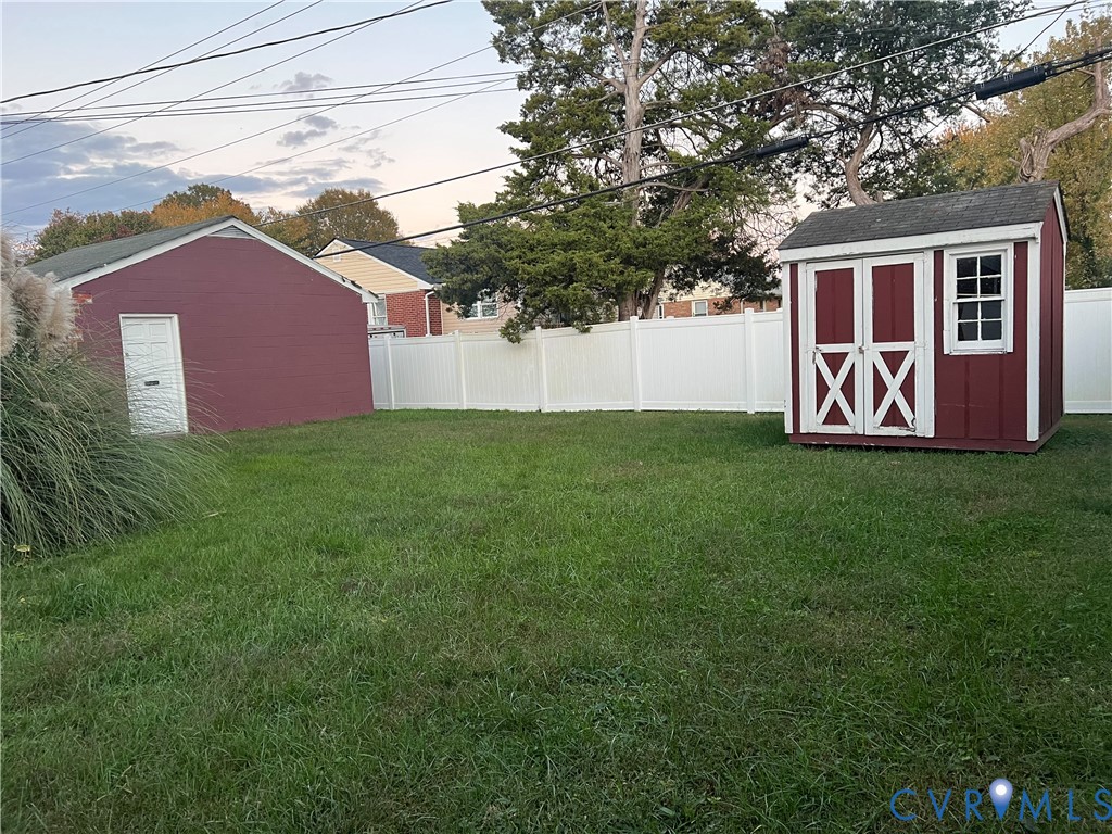 2305 Apollo Road Richmond, VA 23223 - Photo 15 of 16 Fenced backyard featuring a storage shed