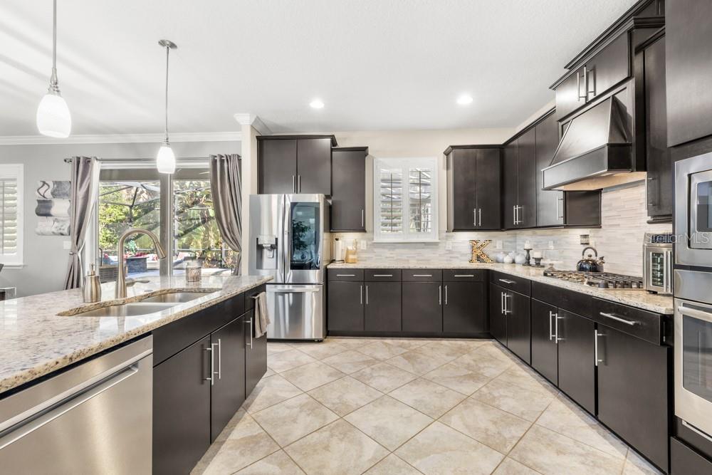 706 Fringe Tree Court Deland, FL 32724 - Photo 15 of 70 a large kitchen with a large counter top appliances and cabinets