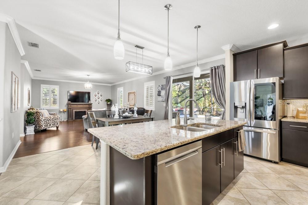 706 Fringe Tree Court Deland, FL 32724 - Photo 16 of 70 a kitchen with stainless steel appliances granite countertop a sink a stove and a refrigerator
