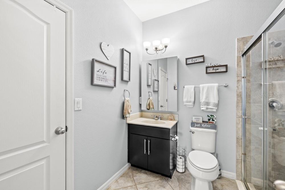 706 Fringe Tree Court Deland, FL 32724 - Photo 18 of 70 a bathroom with a toilet sink vanity and mirror