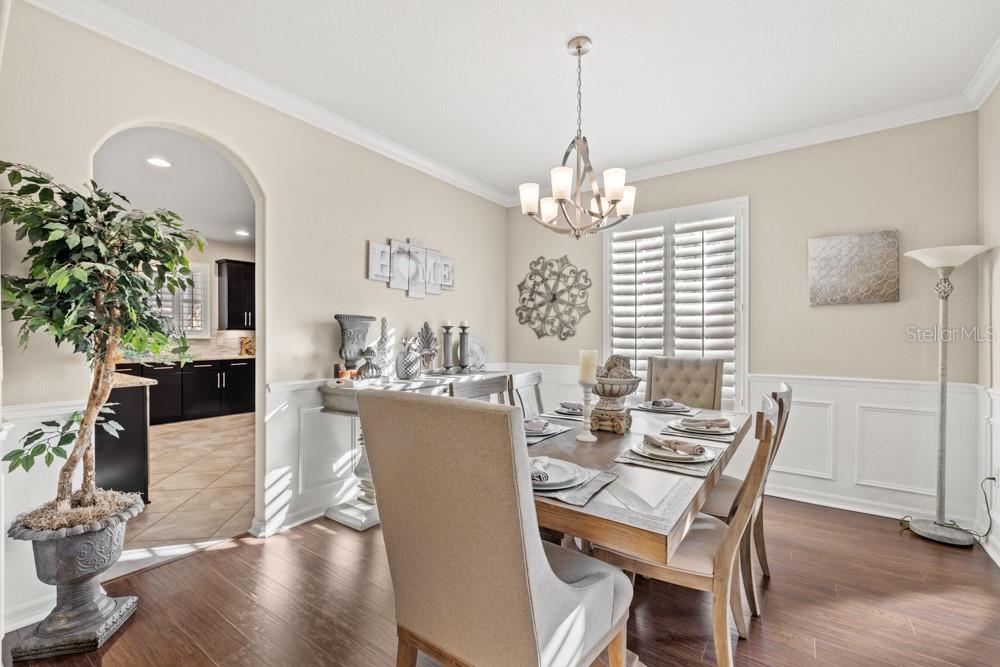 706 Fringe Tree Court Deland, FL 32724 - Photo 21 of 70 a view of a dining room with furniture wooden floor and chandelier