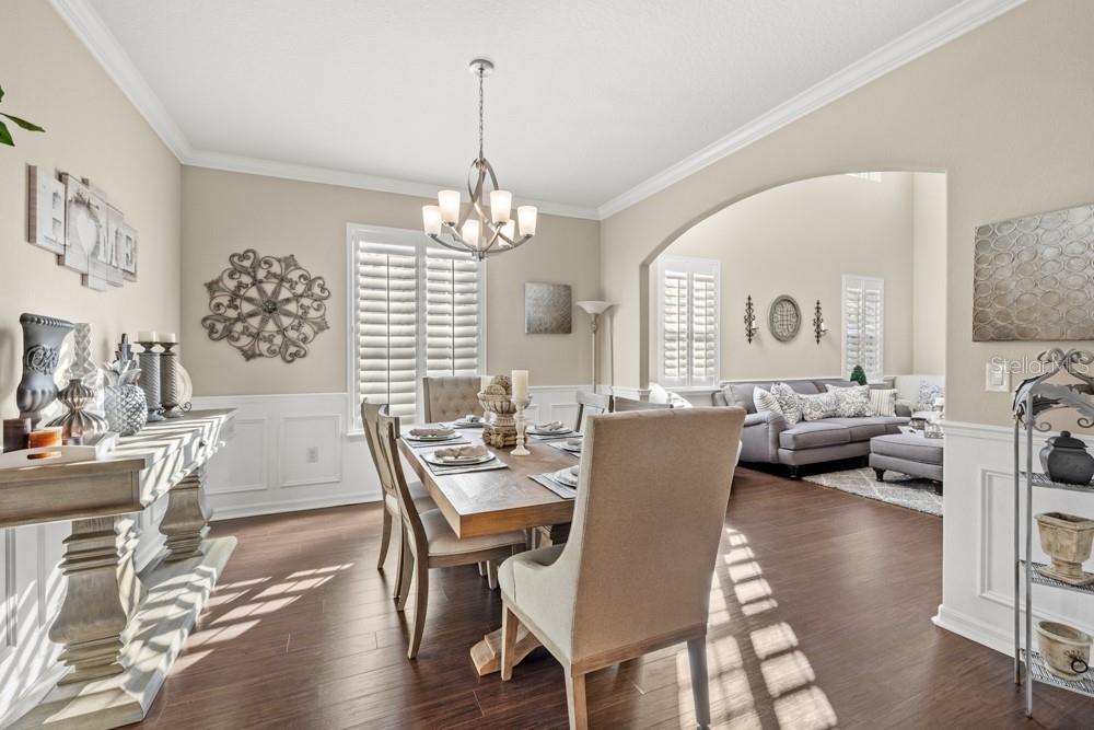 706 Fringe Tree Court Deland, FL 32724 - Photo 22 of 70 a view of a livingroom and dining room with furniture wooden floor a chandelier
