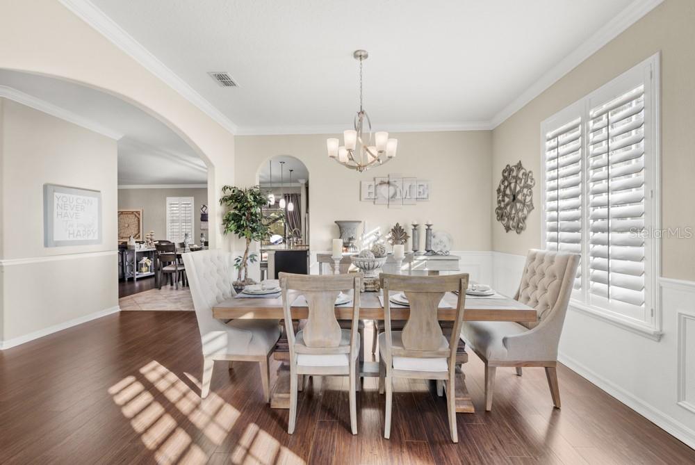 706 Fringe Tree Court Deland, FL 32724 - Photo 23 of 70 a view of a dining room with furniture wooden floor and chandelier