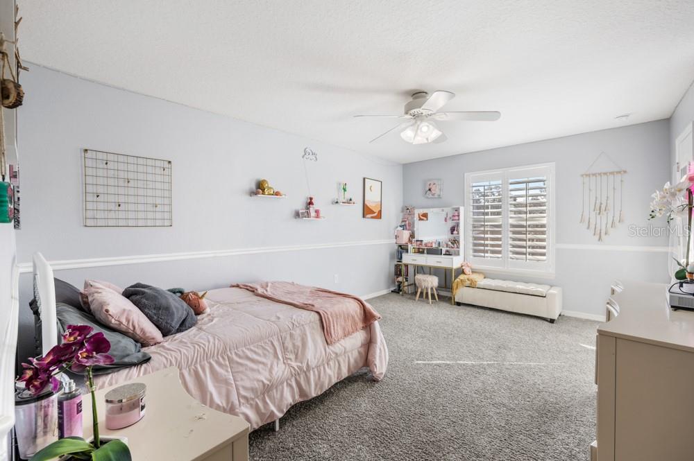 706 Fringe Tree Court Deland, FL 32724 - Photo 30 of 70 a bed room with a bed and a couch