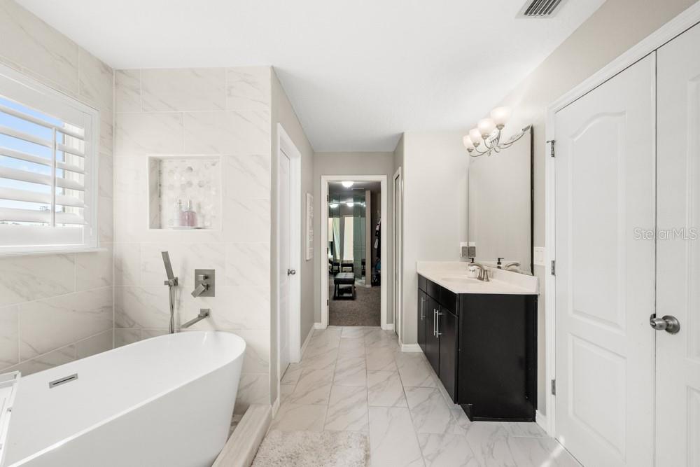 706 Fringe Tree Court Deland, FL 32724 - Photo 43 of 70 a bathroom with a tub sink and mirror
