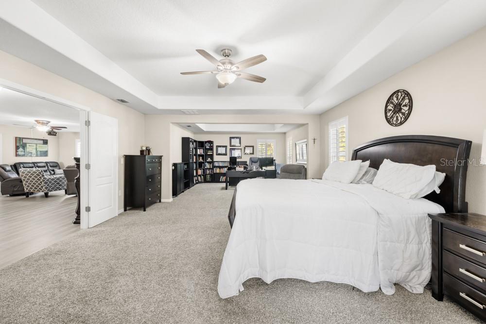 706 Fringe Tree Court Deland, FL 32724 - Photo 44 of 70 a bed room with a bed and a chandelier